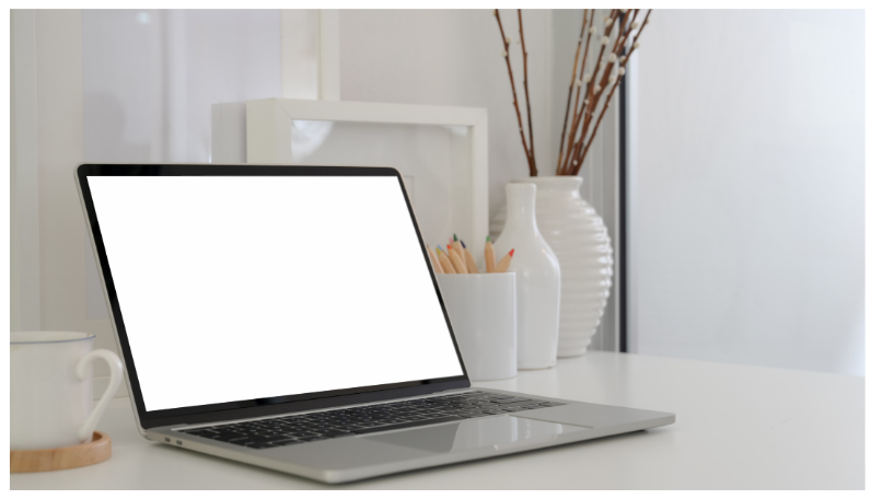 minimalist laptop in white aesthetic background.