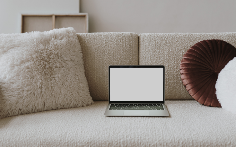 minimalist photo of a laptop in a sofa